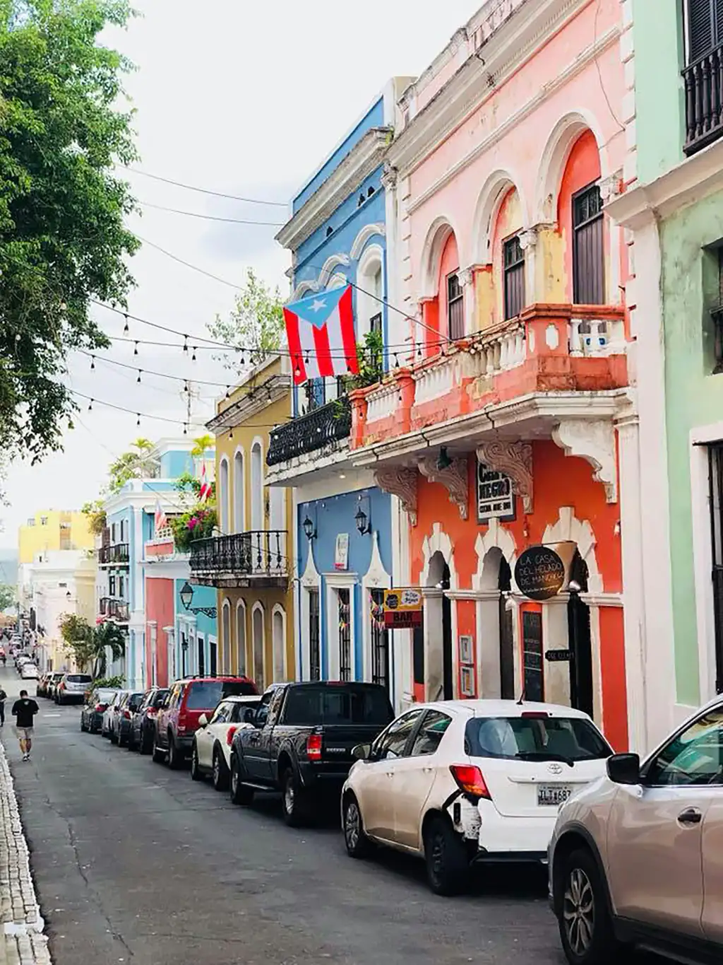 Calle del Viejo San Juan con fachadas de colores y autos estacionados